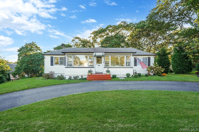 View of front of property with a front lawn and roof with shingles