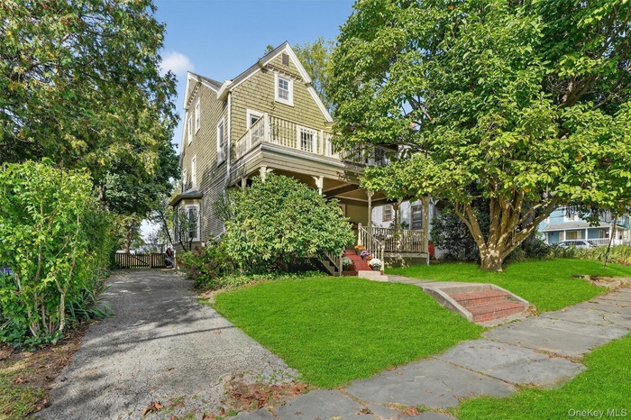 View of front facade featuring a front lawn and a porch