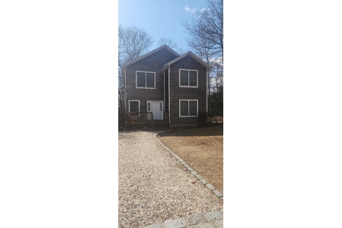 View of front of property featuring a wooden deck