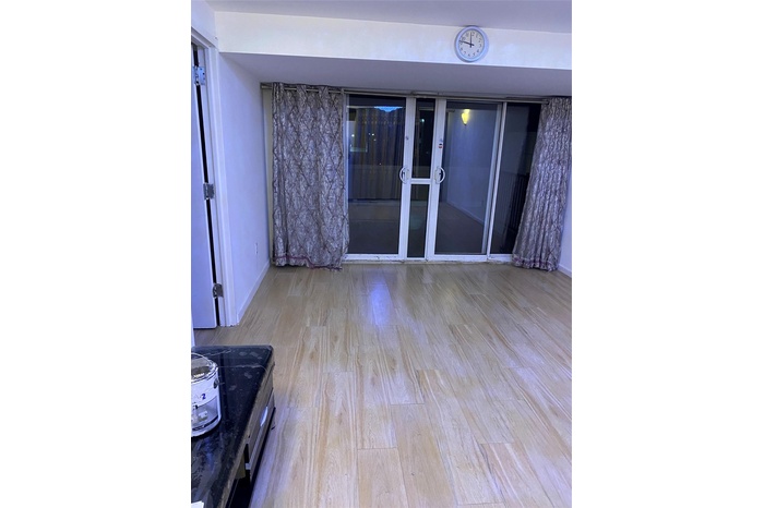 Empty room with wood finished floors and baseboards