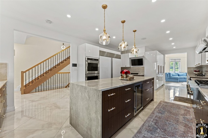 Kitchen featuring modern cabinets, backsplash, recessed lighting, white cabinets, and wine cooler