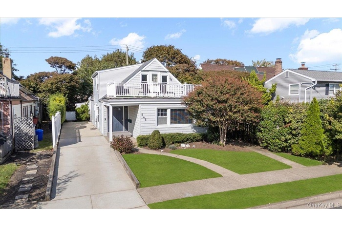 View of front of house with a front lawn and driveway