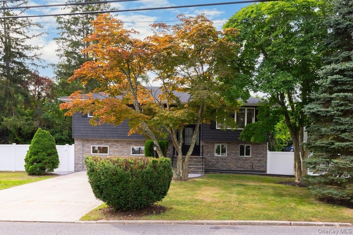 Bi-level home featuring stone siding