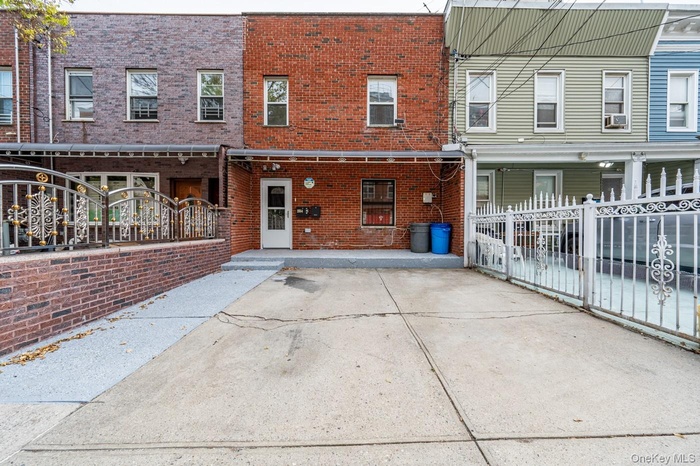 Back of property featuring brick siding and a patio area