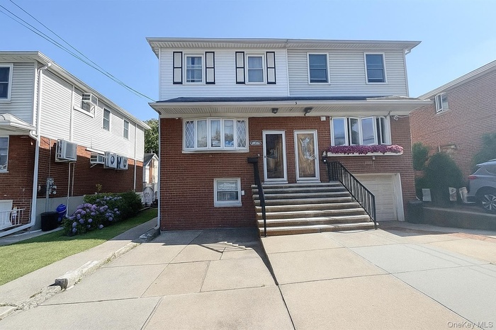 Traditional-style house with brick siding and a garage