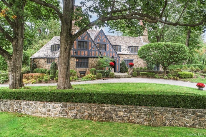 Introducing a magnificently restored Tudor nestled on nearly one acre of landscaped property in Bronxville's Lawrence Park West.
