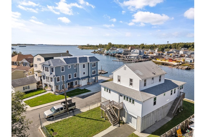 Aerial perspective of suburban area with a nearby body of water