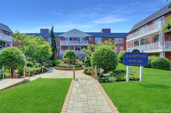 View of property's community with a lawn