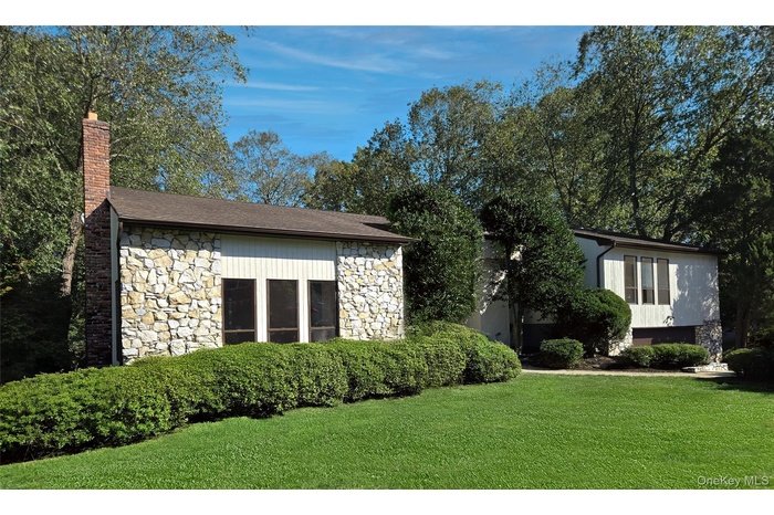 View of front of house, front lawn, and chimney