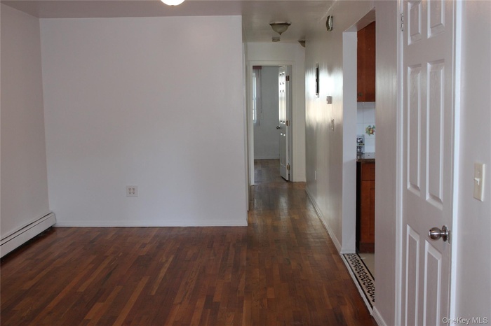 Hall featuring dark wood-style flooring
