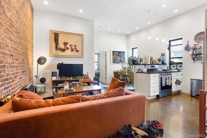 Living room featuring brick wall and recessed lighting