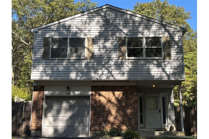 View of front of home with brick siding and a garage