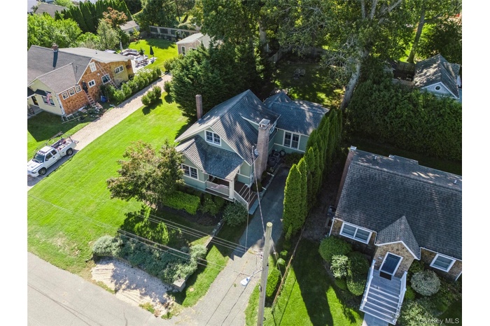 Aerial view of residential area featuring a tree filled landscape