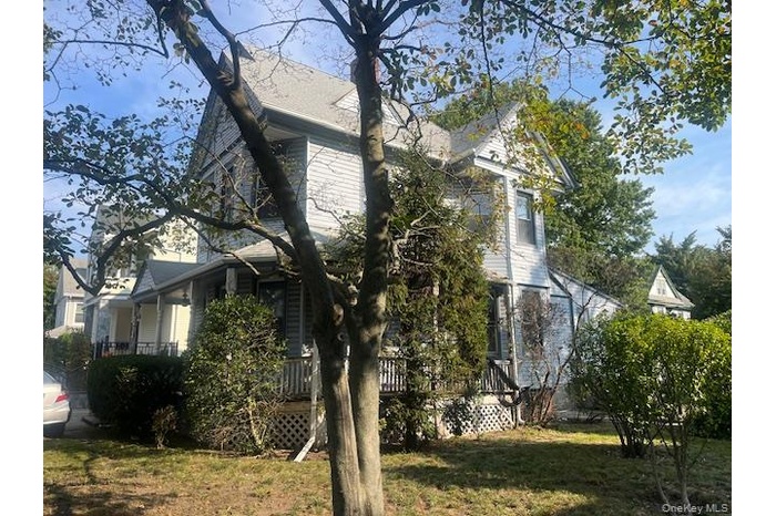 View of property exterior with a deck and a yard