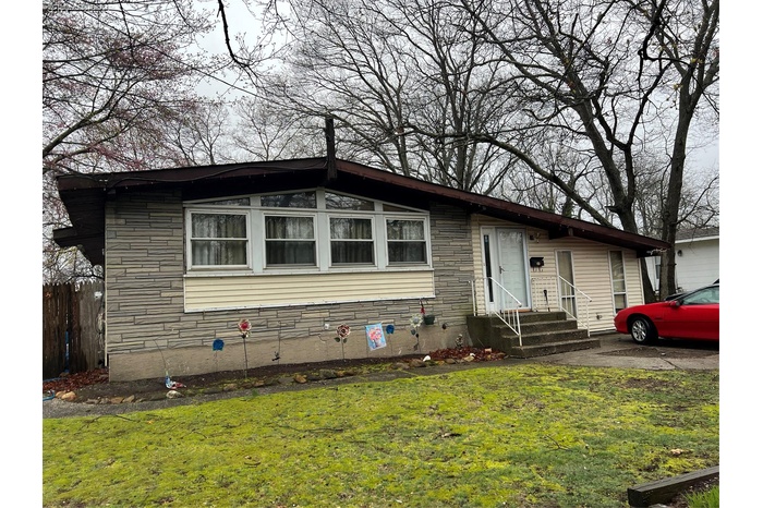 View of front of house with entry steps and stone siding