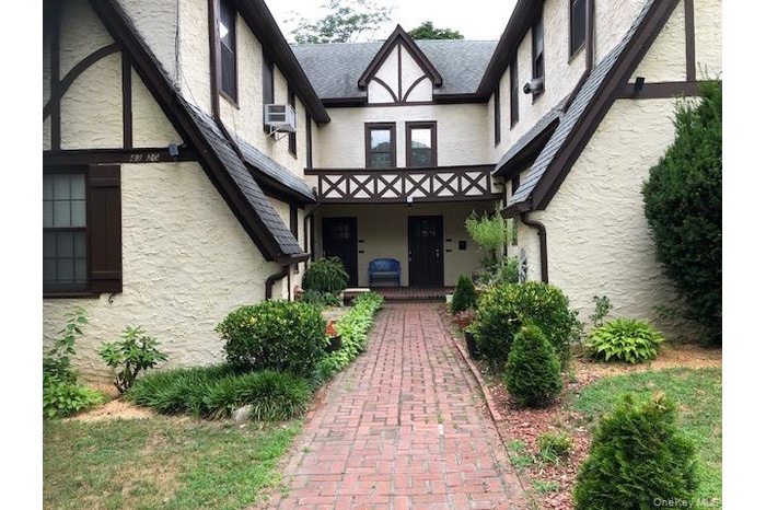 Entrance to property with stucco siding