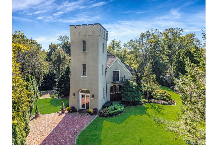 View of front of house featuring a front lawn, french doors, and stucco siding