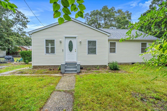 View of front of home with entry steps and roof with shingles