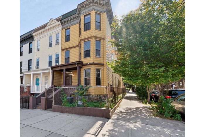 View of property featuring a fenced front yard