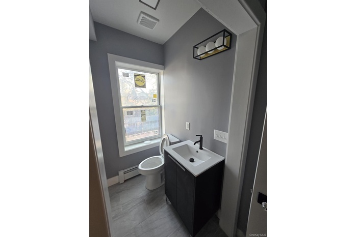 Bathroom featuring vanity and a baseboard radiator