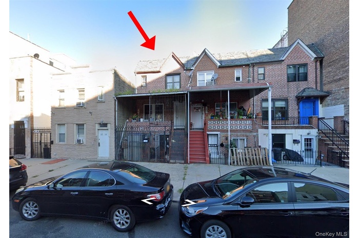 View of front facade featuring stairway and brick siding
