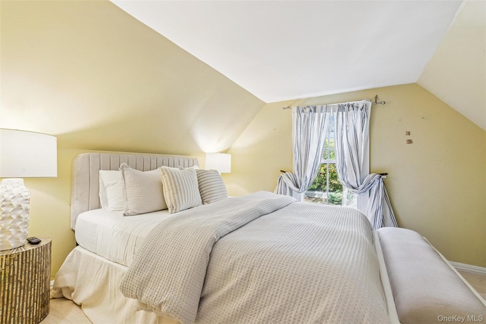 Bedroom featuring lofted ceiling