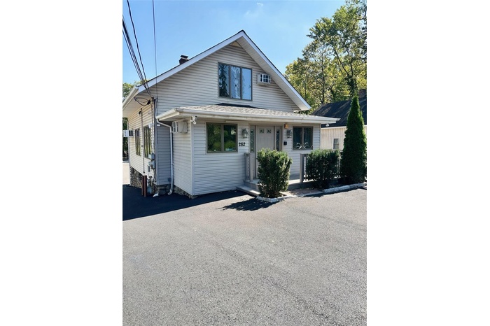 View of front facade featuring a chimney