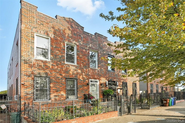 View of front of home with brick siding and a fenced front yard