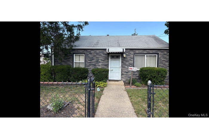 Bungalow-style house with a gate, a fenced front yard, and roof with shingles
