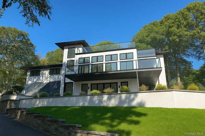Back of property featuring a lawn and stucco siding
