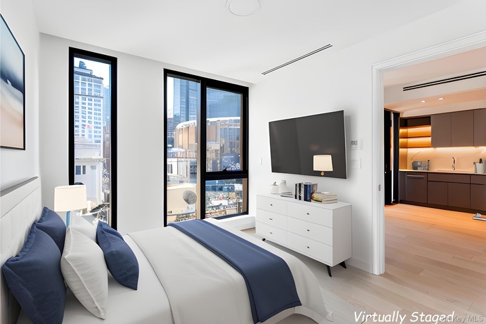Bedroom featuring a wall of windows and light wood finished floors