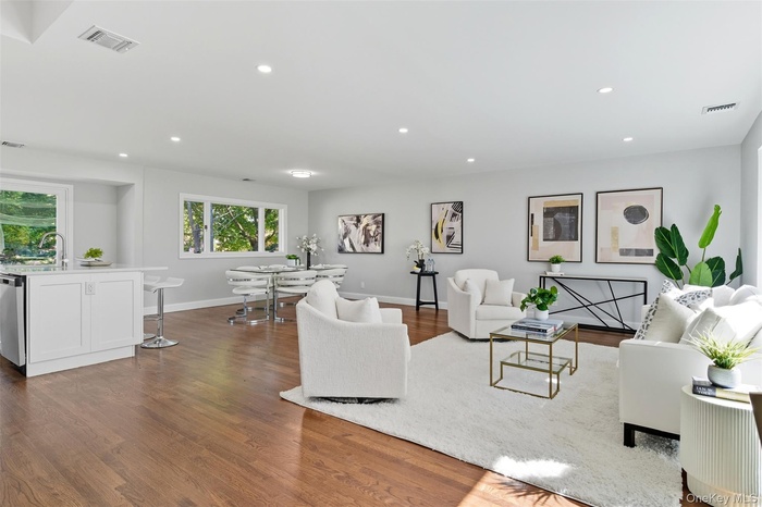 Living area featuring recessed lighting and dark wood-style floors