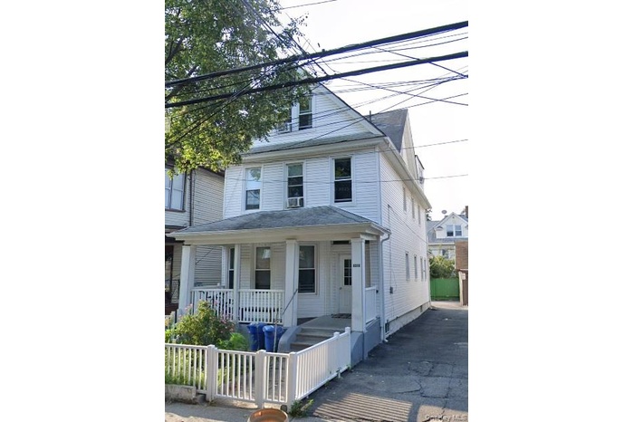 American foursquare style home featuring covered porch