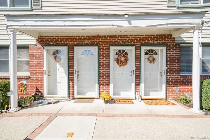 Doorway to property with brick siding