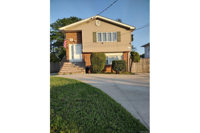 Tri-level home featuring brick siding