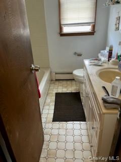 Bathroom with vanity and a baseboard heating unit