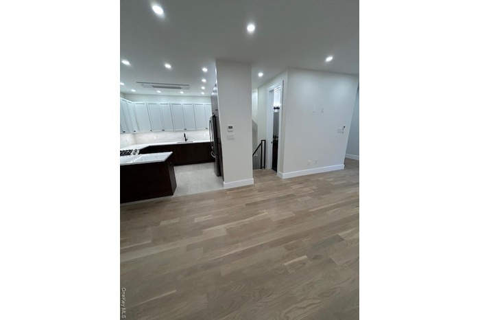 Unfurnished living room with recessed lighting and light wood-style floors
