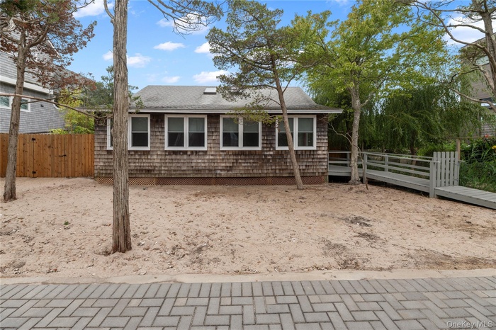 View of front of house with a shingled roof