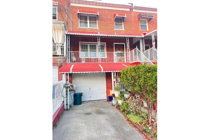Traditional-style home with brick siding and driveway