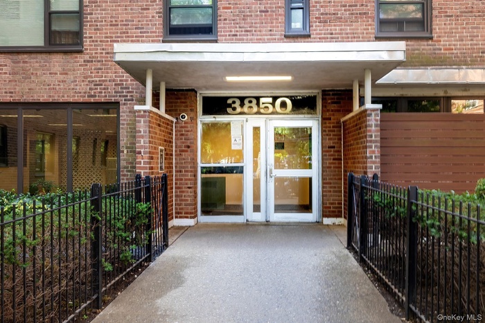 Property entrance featuring french doors and brick siding