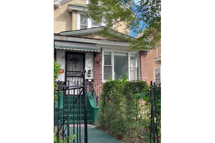 Property entrance featuring brick siding