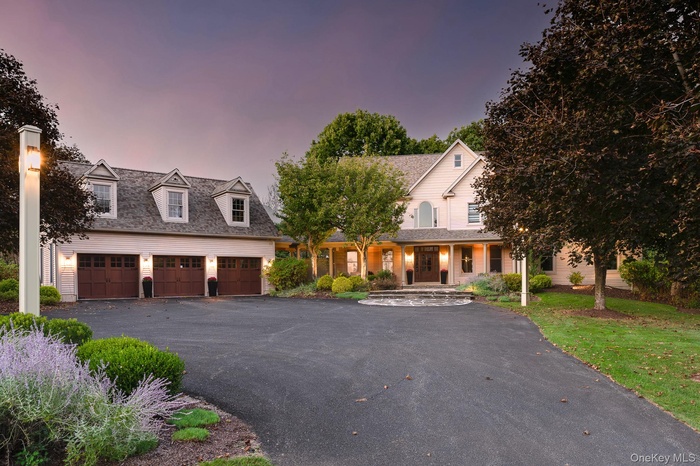 View of front of property with covered porch and driveway