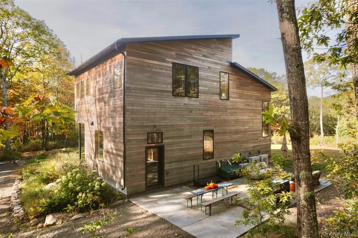 View of home's exterior with a patio and an ac unit