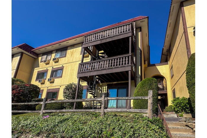 View of apartment building / complex featuring stairway