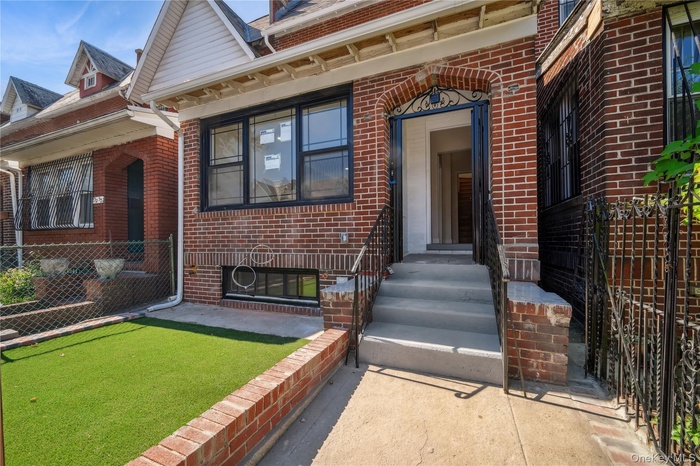 Entrance to property with brick siding