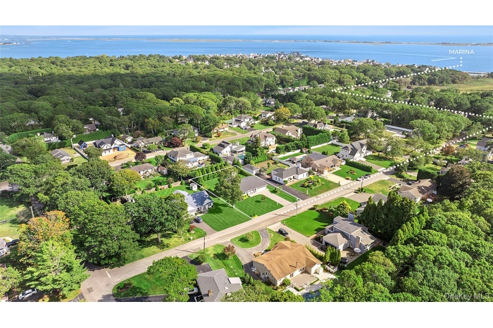 Aerial view of property's location with nearby suburban area and a large body of water