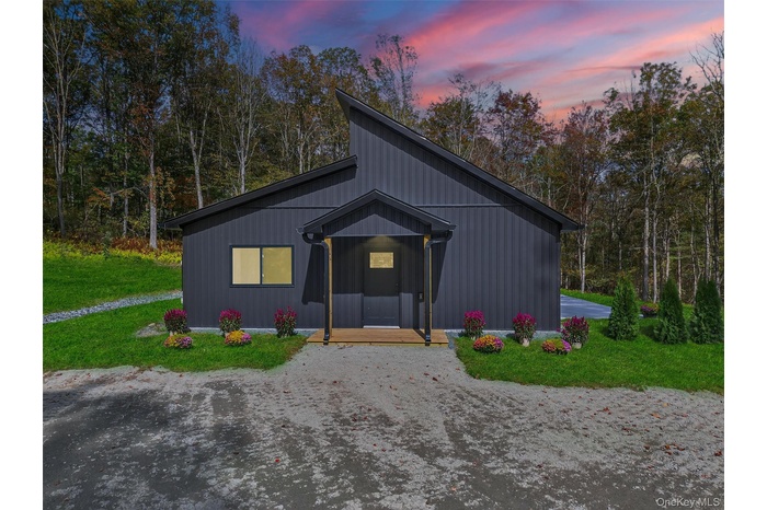 Horse barn featuring a forest view