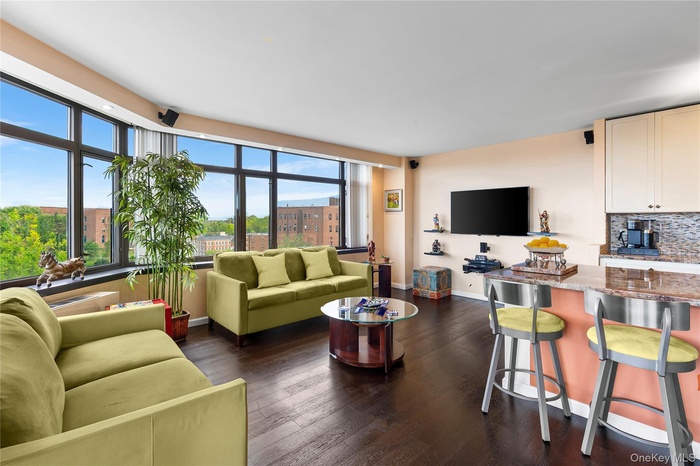 Living area with dark wood finished floors and baseboards