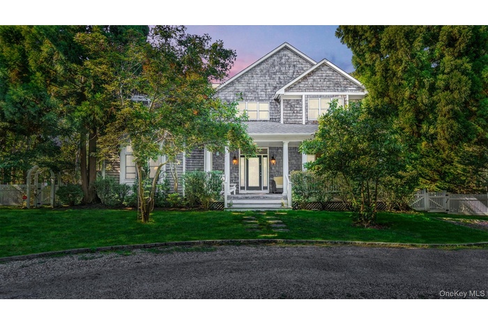 View of front of property with a porch and a gate