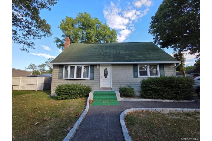 View of front of home featuring a chimney